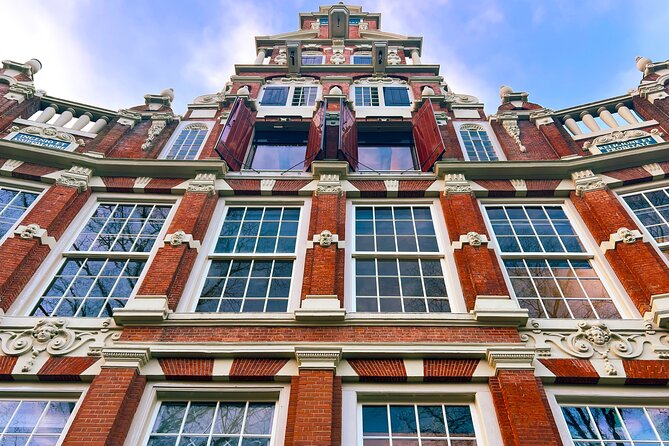 Walking Tour about Golden Age Architecture, private local guide - De Dolphijn: the dolphin symbol and Frans Banning Cocq